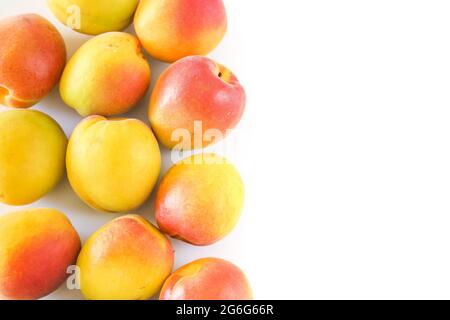 Yellow and red apricot fruit on white background, food concept, copy space, top view. Stock Photo