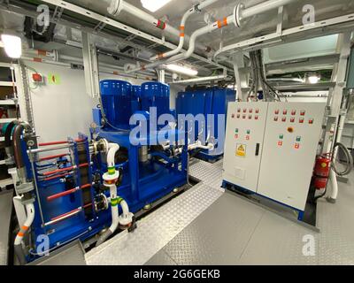 Bright Shiny Engine Room of a Fishing Farm Service Boat including multiple equipments Stock Photo