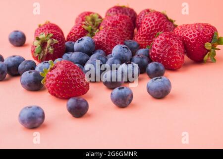 Pile of many fresh ripe fruits isolated on orange background. Stock Photo