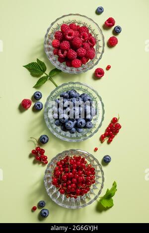flat lay composition with different berries on green background Stock Photo