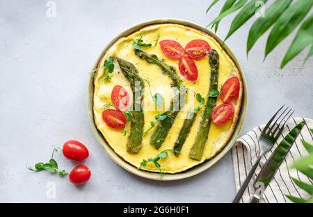 omelette with asparagus, tomatoes and microgreens Stock Photo