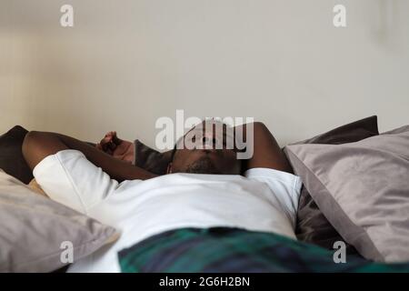 Young African Male Sleeping In Bed At Home Stock Photo