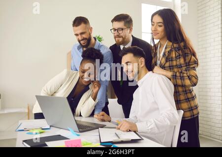 Business people group looking at laptop screen together having online conference Stock Photo