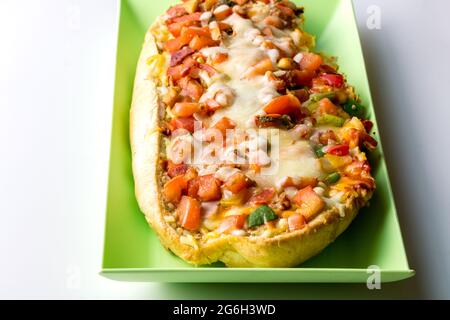 Submarine sandwich roll cut - Sub with tomato, ham, melted cheese and green pepper close up Stock Photo