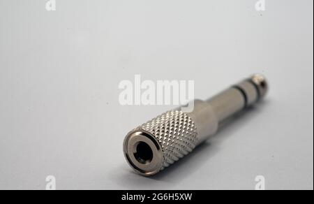 Stereo audio jack adapter plug converter from 3.5 mm to 6.5 mm isolated white background Stock Photo