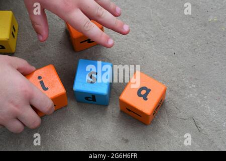 Junior ISA, Individual saving account, a child spelling out ISA with  lettered blocks, Investment Savings Account Stock Photo