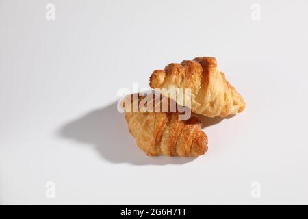 Croissant isolated in  wihite background with sunny light Stock Photo