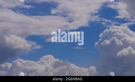 contrasting sky, blue-blue sky, pale white blue sky with scattered cumulus clouds, summer blue sky soft clear. Puffy cloud moving on a windy beach Stock Photo