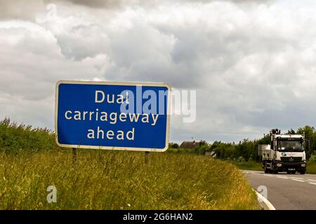Swindon, England - June 2021: Road sign on a bend informing motorists of the start of a dual carriageway ahead. Stock Photo