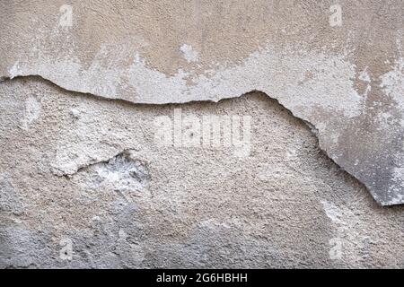 Close up of Cracked concrete wall. Ancient wall with peeling plaster. textured background Stock Photo