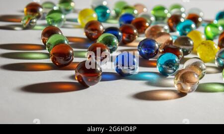 multicolored glass balls on the table indoor closeup Stock Photo