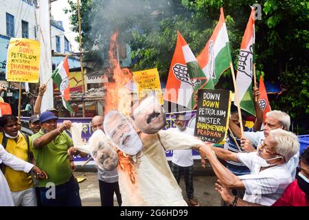 Kolkata, India. 06th July, 2021. Congress party workers burn an effigy with faces of Indian Prime Minister Narendra Modi, Home Minister Amit Shah and Central Petroleum Minister Dharmendra Pradhan in protest against the Bharatiya Janata Party (BJP) government following a rise in fuel price in India. In several states and cities the price has gone over 1.34 dollars (100 rupees). Congress Leaders and workers stage a protest against the Union government over fuel hike in Kolkata. Credit: SOPA Images Limited/Alamy Live News Stock Photo