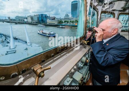 London, UK. 6th July, 2021. On the Captains Bridge - Bernie Bristoll a radio operator and Chief petty Officer in the Royal Navy, served on the ship for 2 years. The Imperial War Museums (IWM) HMS Belfast re-opens after its Covid shutdown and after the refurbishment of many of the displays. Credit: Guy Bell/Alamy Live News Stock Photo