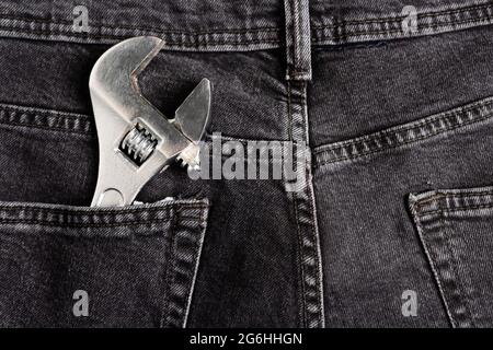 top view of wrench in back pocket of jeans, labor day concept Stock Photo