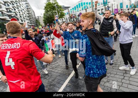 Wembley Stadium, Wembley Park, UK. 6th July 2021.   England fans cheer and throw beer in between Italy and Spain fans for the first Euro 2020 semi-final at Wembley Stadium this evening.  60,000 supporters will be allowed into Wembley for both the semi-finals and final.  Amanda Rose/Alamy Live News Stock Photo