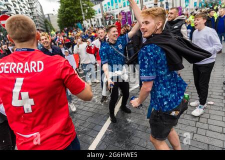 Wembley Stadium, Wembley Park, UK. 6th July 2021.   England fans cheer and throw beer in between Italy and Spain fans for the first Euro 2020 semi-final at Wembley Stadium this evening.  60,000 supporters will be allowed into Wembley for both the semi-finals and final.  Amanda Rose/Alamy Live News Stock Photo