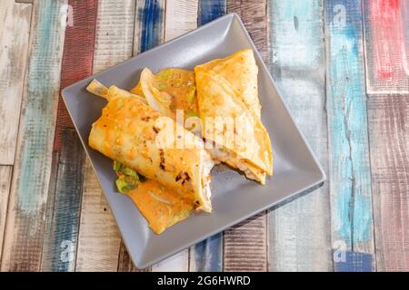 seafood crepe cut in half and covered with sauce Stock Photo