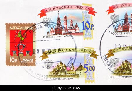 MOSCOW, RUSSIA - MARCH 4, 2020: Postage stamp printed in Russia with stamp of Segezha shows Moscow and Novgorod Kremlins, Coat of arms of Alexandrov c Stock Photo