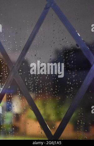 Raindrops on a leaded window pane. Stock Photo