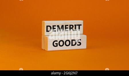 Demerit goods symbol. Wooden blocks with words Demerit goods on beautiful orange background, copy space. Business and demerit goods concept. Stock Photo