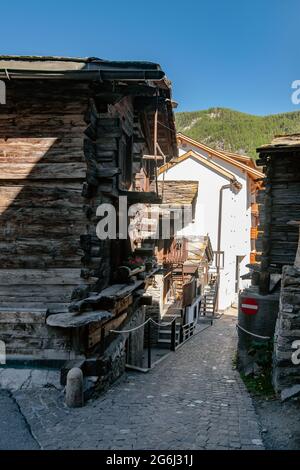 Old Village Houses in an Alp valley around Zermatt region in Switzerland; wooden shepherd's houses, Mountains, Rural, Traditional Stock Photo