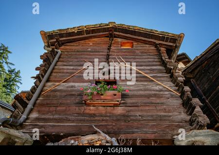 Old Village Houses in an Alp valley around Zermatt region in Switzerland; wooden shepherd's houses, Mountains, Rural, Traditional Stock Photo