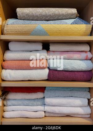 Multi-colored cotton terry towels are stacked Stock Photo