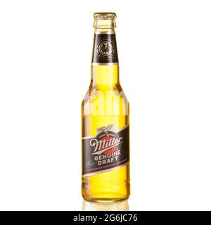 Miller beer bottle on glass table isolated against white background - Volgograd, Russia - June 03, 2021. Stock Photo