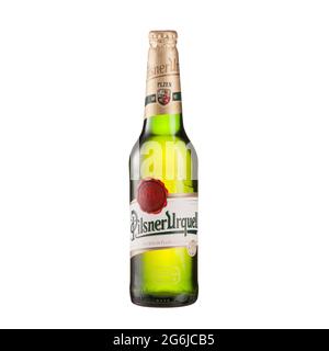 Pilsner Urquell beer bottle on glass table isolated against white background - Volgograd, Russia - June 03, 2021. Stock Photo
