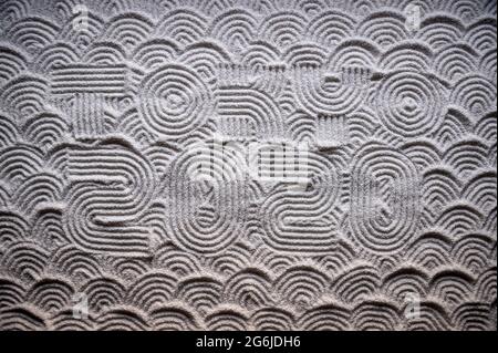 MIAMI, USA - August, 2019: Japanese Zen garden raked with the word TOKYO 2020 in capital letters in textured white sand with wave pattern Stock Photo