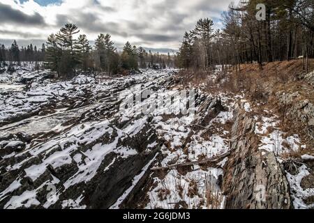 Rugged rocky snow covered landscape along the St. Louis River in Jay Cooke State Park, Carlton, Minnesota USA. Stock Photo