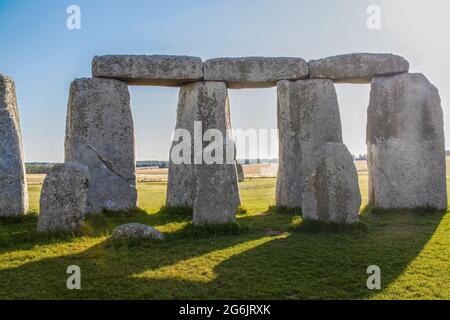 Standing stones of Stonehenge-the worlds most famous prehistoric monument - Closeup from inside the circle with dramatic shadows and Salisbury Plain i
