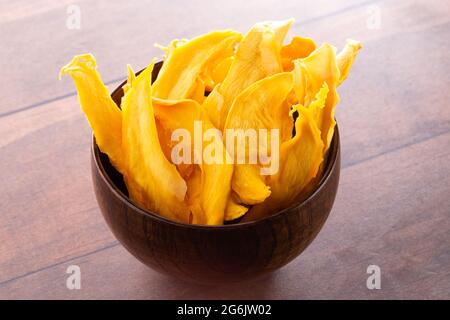 Dehydrated Mango Slices on a Wooden Table Stock Photo