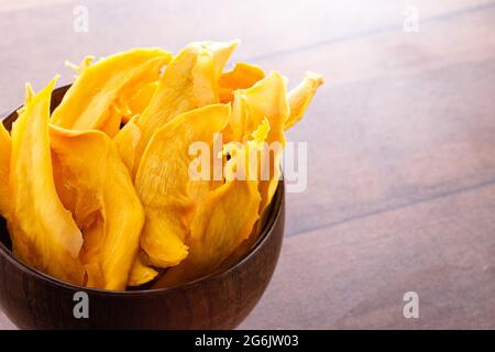 Dehydrated Mango Slices on a Wooden Table Stock Photo