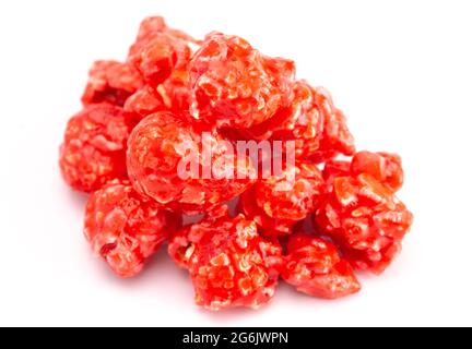Red Cinnamon Popcorn on a White Background Stock Photo
