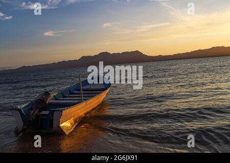 Un Bote de pesca flota en el agua atardecer en la playa de frente  Isla del Tiburon en la localidad de Punta Chueca durante la celebración año nuevo Seri en la comunidad de Punta Chueca el 30 junio 2021 en Hermosillo, Mexico.(Foto by Luis Gutierrez / Norte Photo )  A fishing boat floats in the sunset water on the beach in front of Isla del Tiburon in the town of Punta Chueca during the Seri New Year celebration in the community of Punta Chueca on June 30, 2021 in Hermosillo, Mexico. (Photo by Luis Gutierrez / North Photo) Stock Photo