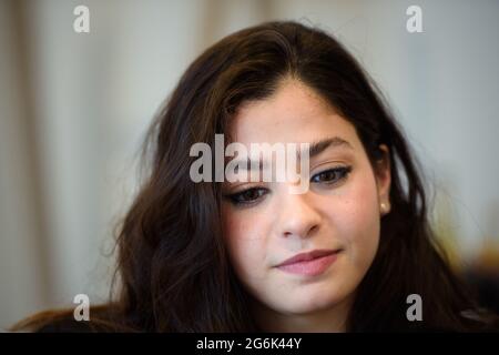 Hamburg, Germany. 12th June, 2021. Yusra Mardini, a swimmer, sits in a meeting room of a Hamburg hotel during an interview. Credit: Gregor Fischer/dpa/Alamy Live News Stock Photo