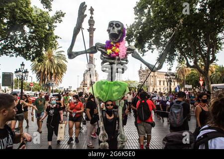 Barcelona, Spain. 06th July, 2021. A Mexican skeleton doll seen during the event.Barcelona welcomes the 421 Squadron of the Zapatista Army of National Liberation (EZLN), a libertarian socialist political and militant group of Mexico, on their way through Europe. Composed of different members. The 421 Squad has been received at the Columbus Monument by local collectives and social organizations. (Photo by Thiago Prudencio/SOPA Images/Sipa USA) Credit: Sipa USA/Alamy Live News Stock Photo