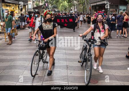 Barcelona, Spain. 06th July, 2021. Women seen with bicycles, during the event.Barcelona welcomes the 421 Squadron of the Zapatista Army of National Liberation (EZLN), a libertarian socialist political and militant group of Mexico, on their way through Europe. Composed of different members. The 421 Squad has been received at the Columbus Monument by local collectives and social organizations. (Photo by Thiago Prudencio/SOPA Images/Sipa USA) Credit: Sipa USA/Alamy Live News Stock Photo