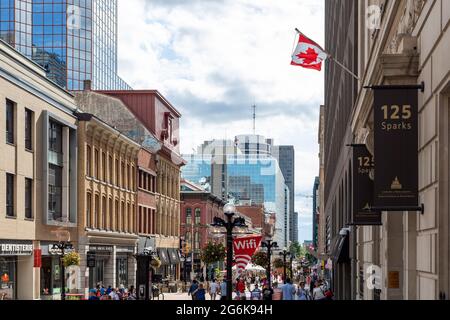 Ottawa, Canada - July 1, 2021: Cityscape street view with walking people in downtown of Ottawa. Sparks street during Canada day holiday. Stock Photo