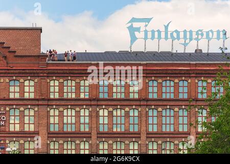 People on the roof of Finlayson old factory building in Tampere Finland Stock Photo