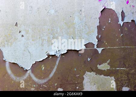 Peeling, cracked and flakey paint on a brown metal surface Stock Photo