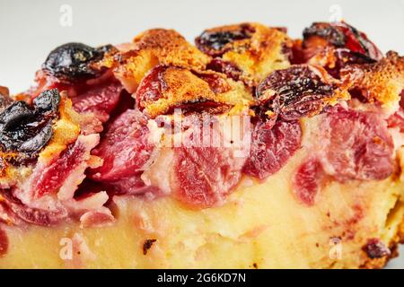 Slice of Finished Cherry Pie, clafoutis on gray plate with fork. Stock Photo