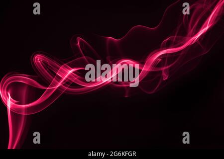 Pink smoke isolated on black background. Stock Photo