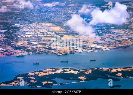 Aerial view of coastal construction or port areas in Strait of Malacca, on airplane route to Malaysia or Singapore. Airplane shot Stock Photo