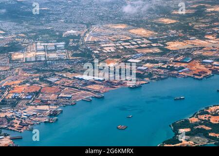 Aerial view of coastal construction or port areas in Strait of Malacca, on airplane route to Malaysia or Singapore. Airplane shot Stock Photo