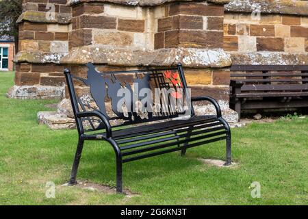 World War 1 memorial bench outside the church of St George the Martyr, Wootton, Northampton, UK Stock Photo