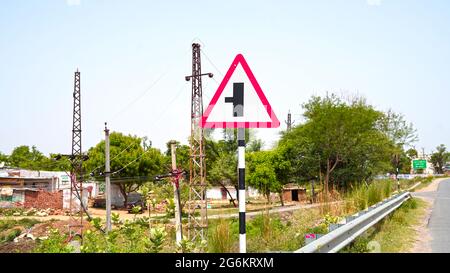07 July 2021- Reengus, Sikar, India. Asphalt road sign board to move left side. Indian traffic rules and regulations concept. Stock Photo