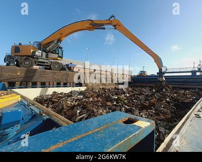 A crane unloads cargo from a ship Stock Photo - Alamy