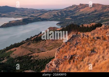 Sunrise over Porthills, Christchurch, Aotearoa New Zealand. The Port Hills are a 12 million-year-old remnant of the Lyttelton volcano crater. Wind, ra Stock Photo